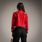 Torera Roja con bordados dorados y apliques negros