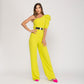 Mono de fiesta amarillo fluor con cuerpo asimétrico y cinturon metalizado